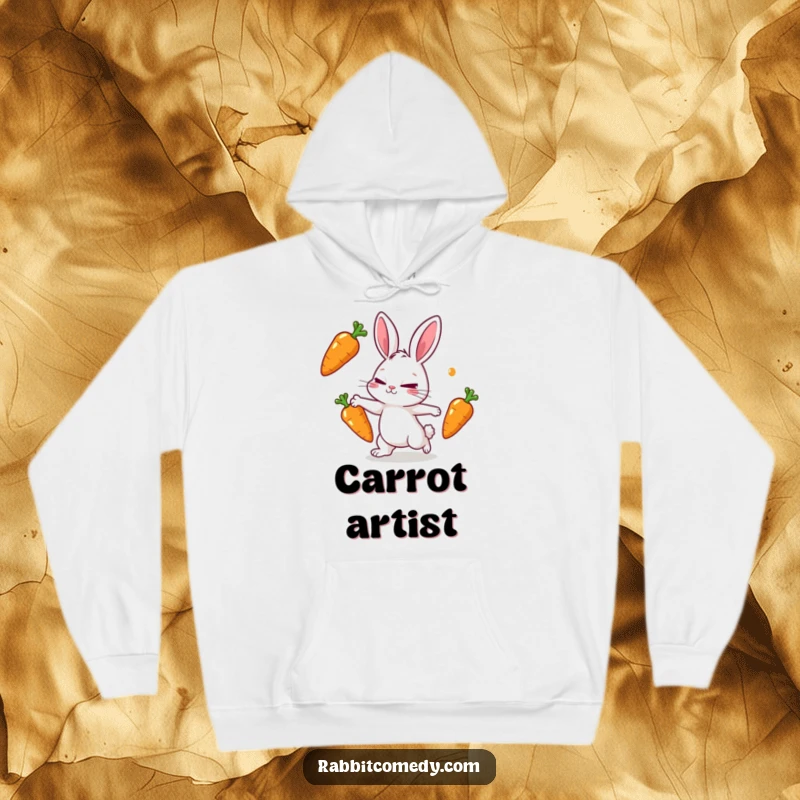 Funny rabbit hoodie showing a rabbit character intently juggling three shiny carrots with a determined squint and focused expression.