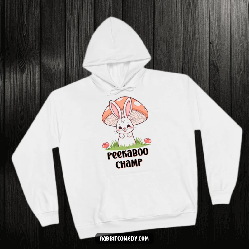 Funny hoodie depicting a cartoon rabbit with a sly grin peeking from behind a giant, striped mushroom.