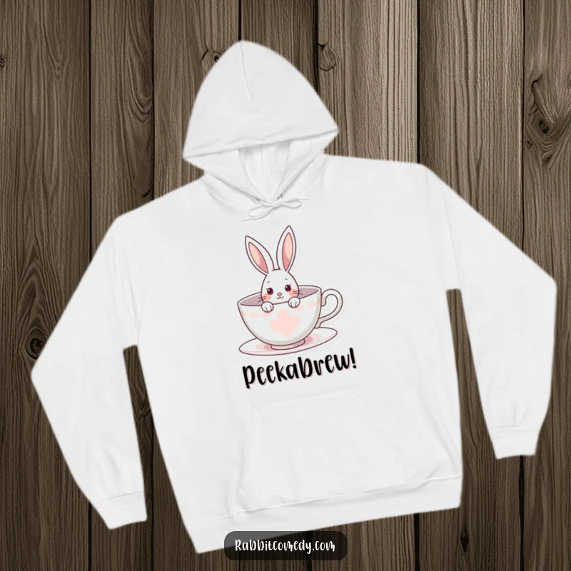 Funny rabbit hoodie with a curious bunny peeking from a giant teacup, designed for cozy comfort and radiating whimsical charm.