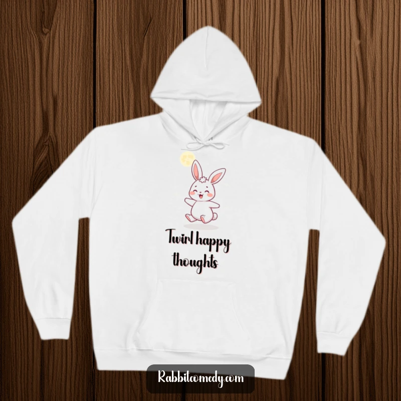Funny hoodie depicting a gleeful cartoon rabbit spinning with delight beneath a sparkling, glittery moon, offering comfort and magical vibes.
