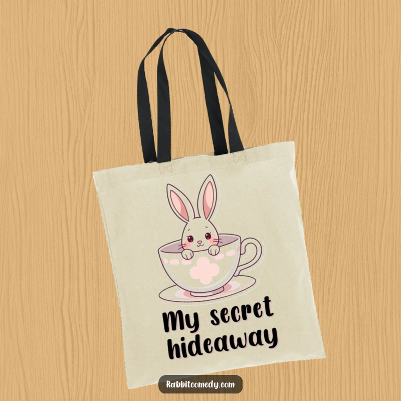 Funny rabbit tote bag featuring a curious bunny peeking from a giant teacup, ideal for carrying items with a hint of whimsical wonder.